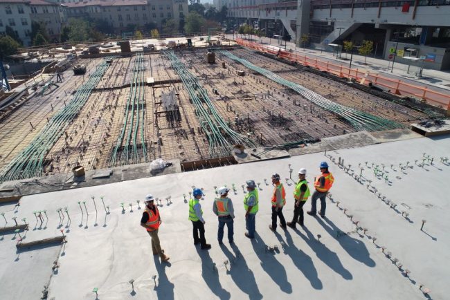 Construction workers overlooking worksite