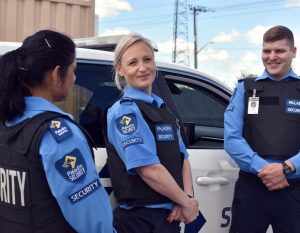 3 Paladin Security guards in front of a mobile patrol vehicle